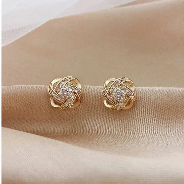 Goudkleurige spiraaloorbellen met kristalglans