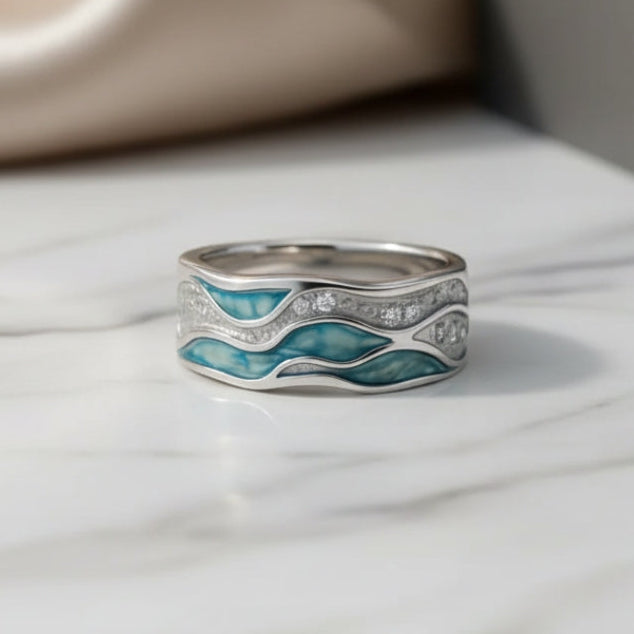 Zilverkleurige ring met turkooiskleurige golven