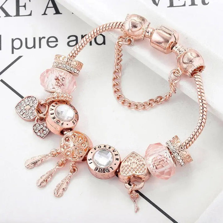 Roze dromenvanger-armband met zilverkleurige bedels