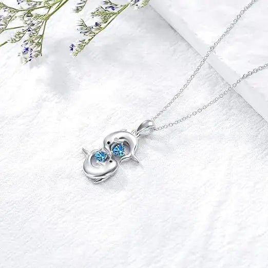 Zilverkleurige ketting met dubbele dolfijnen en blauwe kristalglans