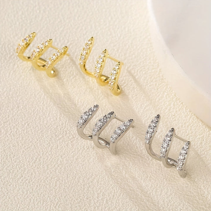 Elegante oorbellen met kristalsteentje in drievoudige zetting