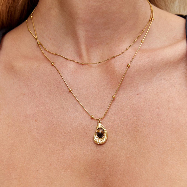 Elegante goudkleurige ketting met tijgeroog-steen